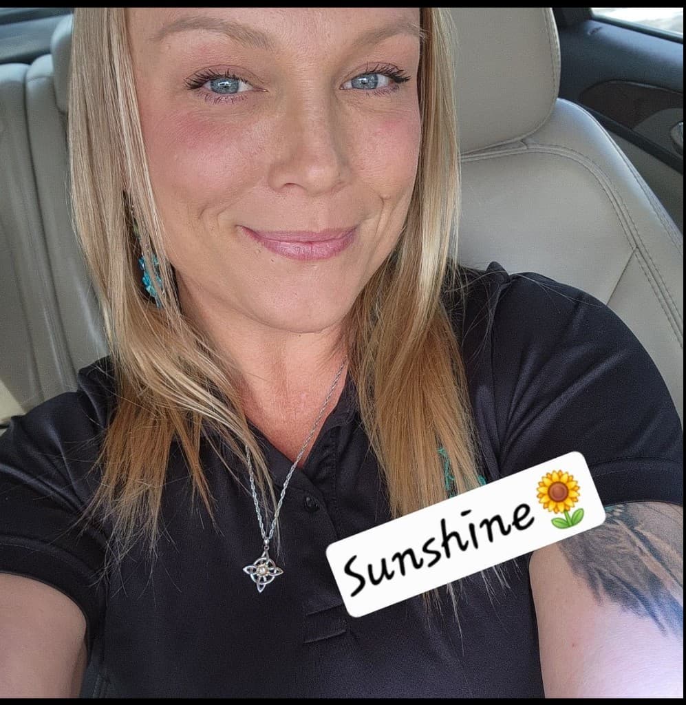 Sheena Hotaling, owner of Sunshine's Handy Gal Services, smiling in a black polo shirt